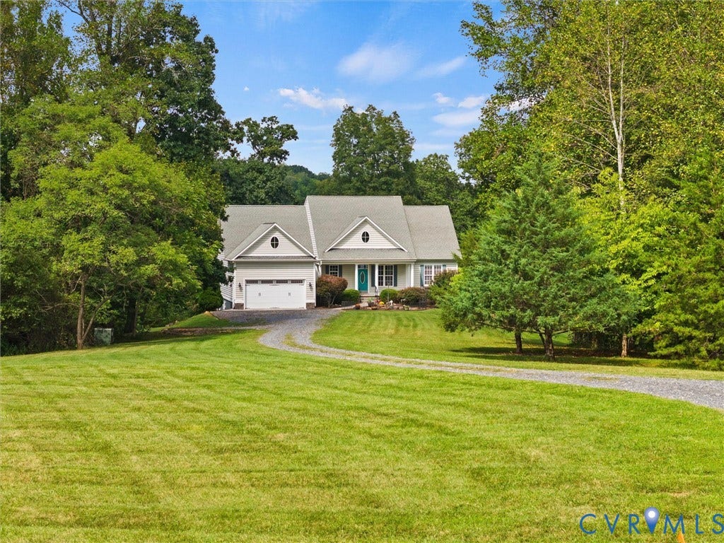 6126 Cartersville Road, Powhatan, VA 23139 Light-colored exterior with a front-facing garage and a prominent front entrance