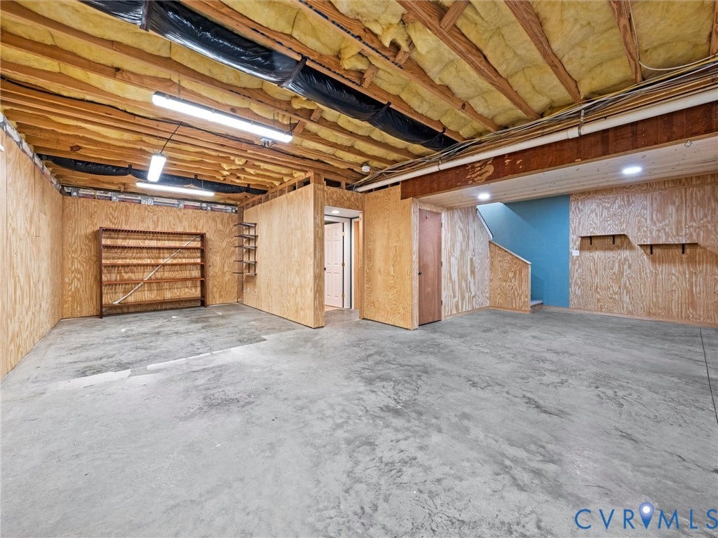 6126 Cartersville Road, Powhatan, VA 23139 Concrete flooring, exposed ceiling joists, wood-paneled walls, built-in shelving, and recessed lighting