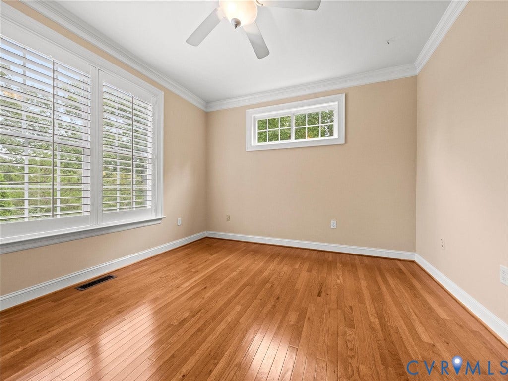 6126 Cartersville Road, Powhatan, VA 23139 Wood-finish flooring throughout, multiple windows with white plantation shutters, crown molding, and a ceiling fan