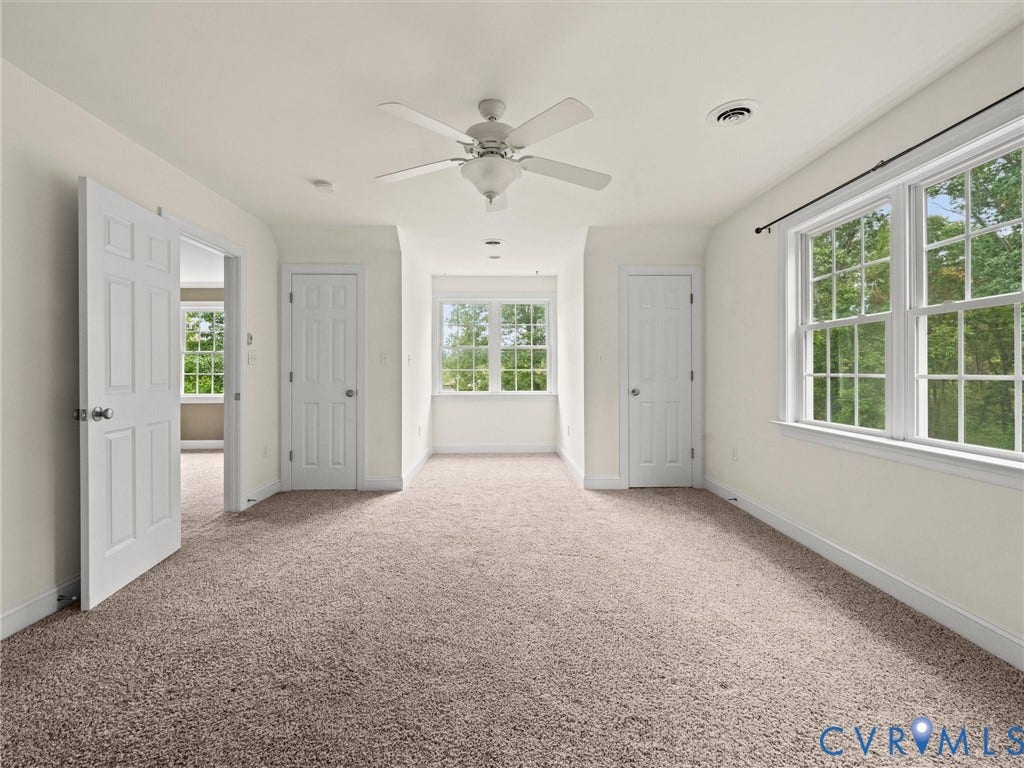 6126 Cartersville Road, Powhatan, VA 23139 Carpeted room featuring multiple windows, a ceiling fan, and white paneled doors