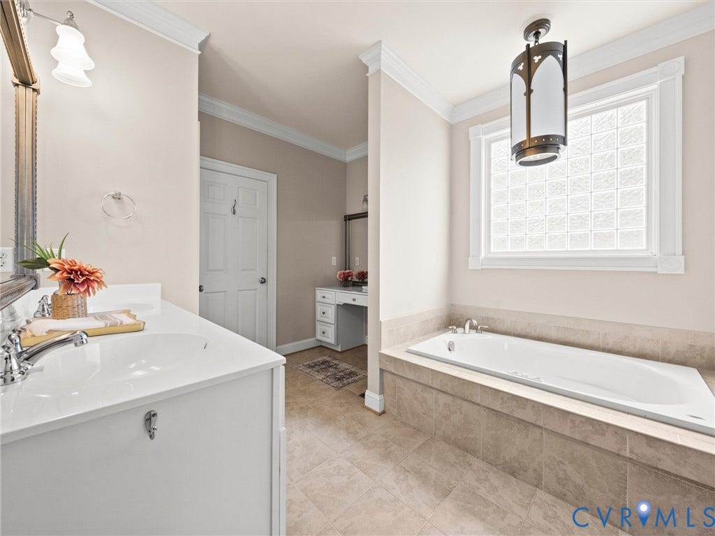 6126 Cartersville Road, Powhatan, VA 23139 Built-in soaking tub with tile surround, block glass window, and decorative pendant light