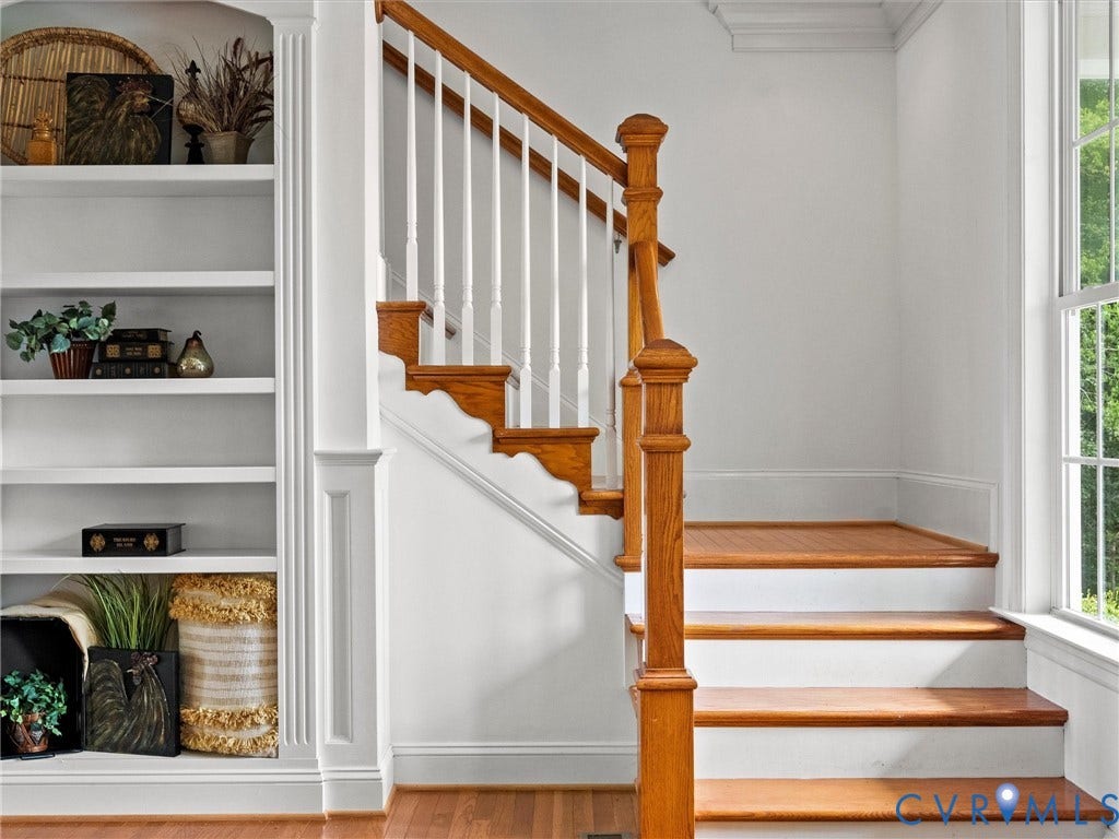 6126 Cartersville Road, Powhatan, VA 23139 Hardwood staircase with white risers, custom built-in shelving, white balusters, and wood-finish flooring