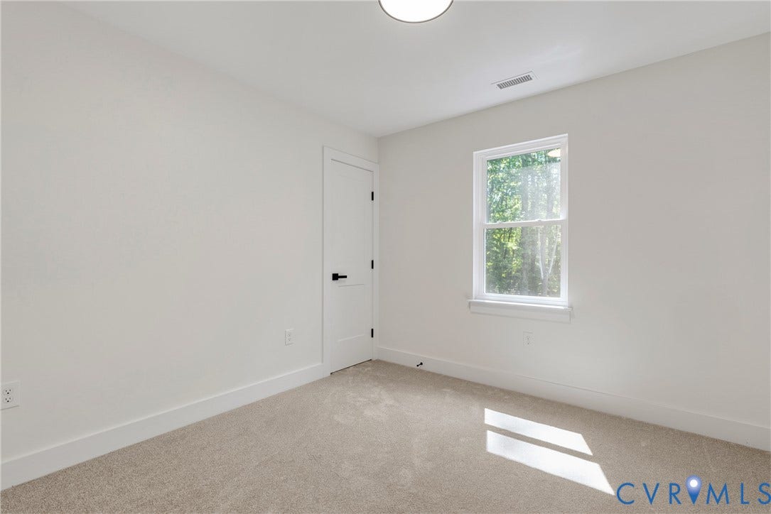 6465 Anderson Highway, Powhatan, VA 23139 Neutral wall paint, light-toned carpeting, white interior door with black hardware, and a single window