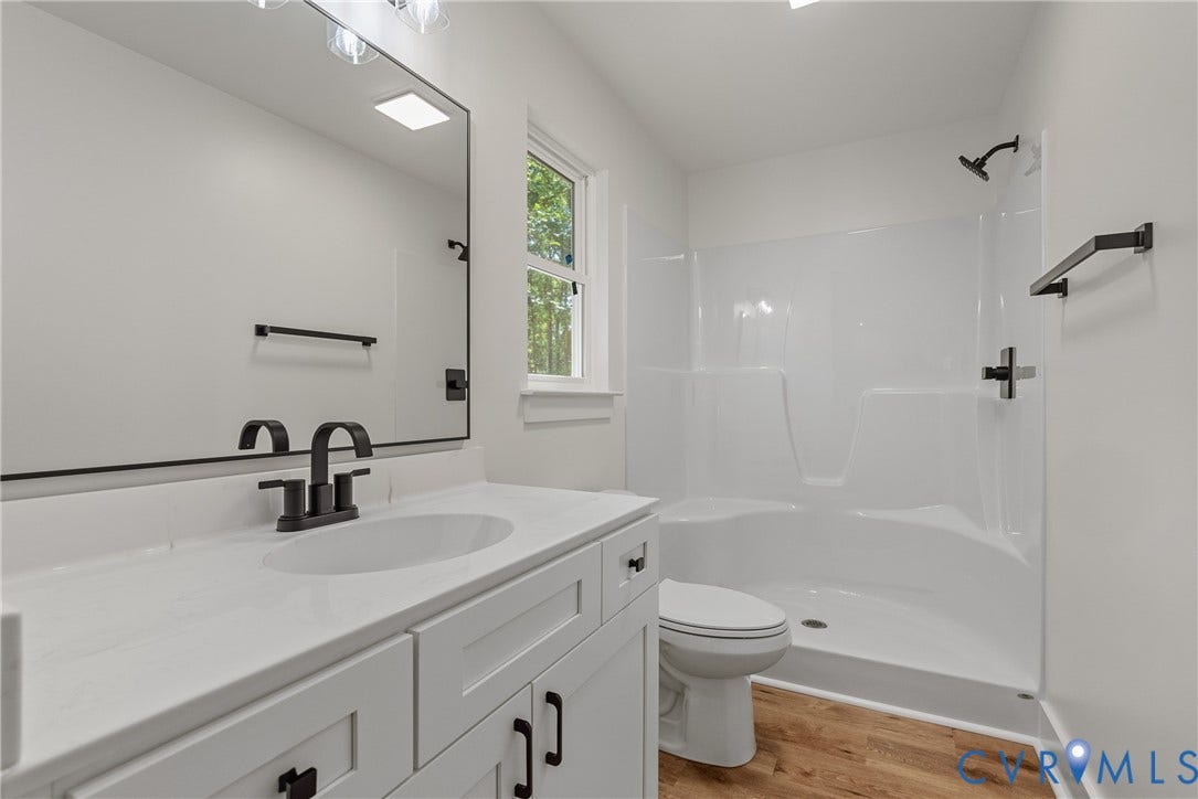 6465 Anderson Highway, Powhatan, VA 23139 White shaker vanity with a solid surface countertop and integrated sink