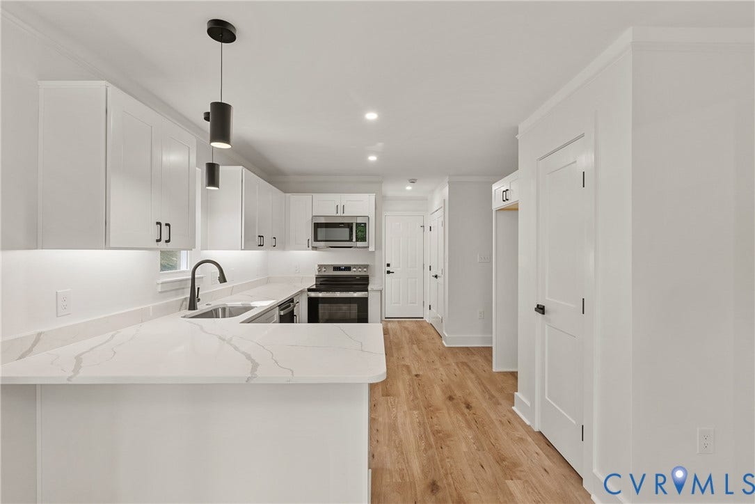 6465 Anderson Highway, Powhatan, VA 23139 Kitchen featuring white shaker-style cabinetry, quartz countertops, stainless steel appliances, a matte black gooseneck faucet, and wood-finish flooring