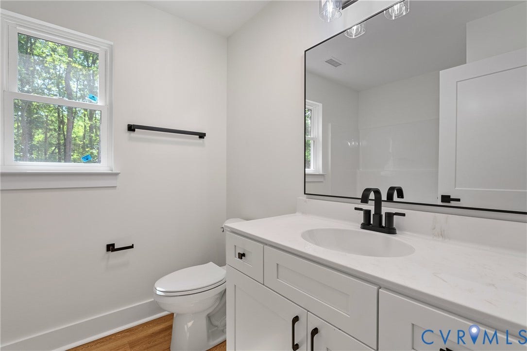 6465 Anderson Highway, Powhatan, VA 23139 White vanity with a solid surface countertop, undermount sink, and matte black faucet