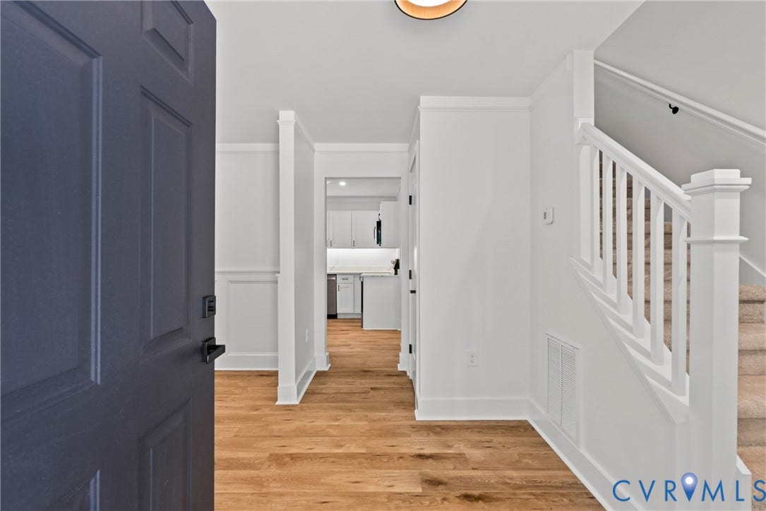 6465 Anderson Highway, Powhatan, VA 23139 Hardwood-style flooring, white paneling, white staircase, and a dark paneled entry door