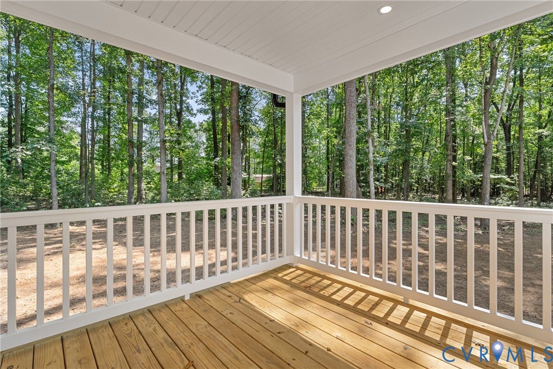 6465 Anderson Highway, Powhatan, VA 23139 Covered outdoor deck with wood-finish flooring, white railing, and recessed lighting, surrounded by mature trees