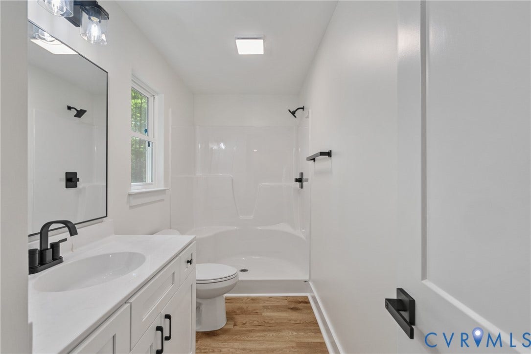 6465 Anderson Highway, Powhatan, VA 23139 White vanity with integrated sink, black faucet, and matte black hardware