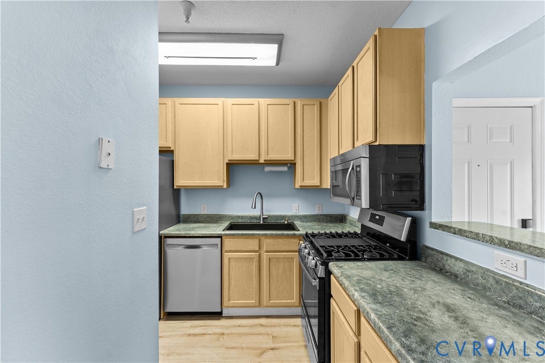 821 Brassie Lane, #E, The Crossings Golf Course Area, Glen Allen, VA 23059 Kitchen featuring light-finish cabinetry, stone-texture countertops, integrated stainless steel appliances, a deep undermount sink with a gooseneck faucet, and wood-finish flooring