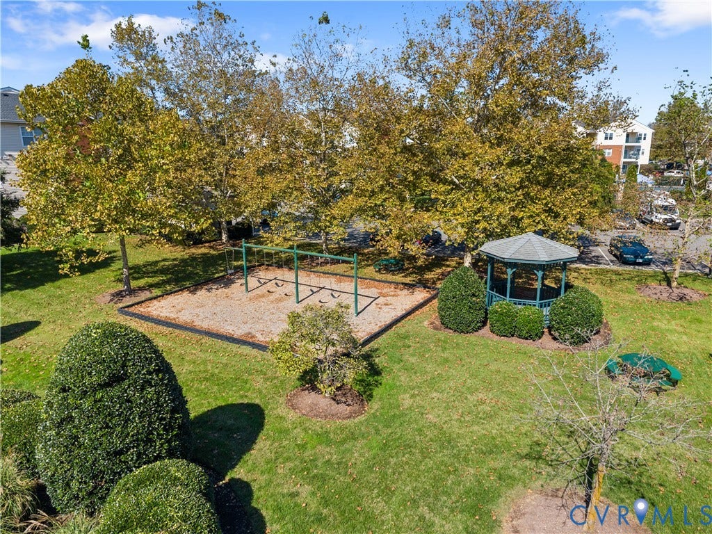 821 Brassie Lane, #E, The Crossings Golf Course Area, Glen Allen, VA 23059 Common area grounds featuring a gazebo, swing set, manicured lawn, and mature trees
