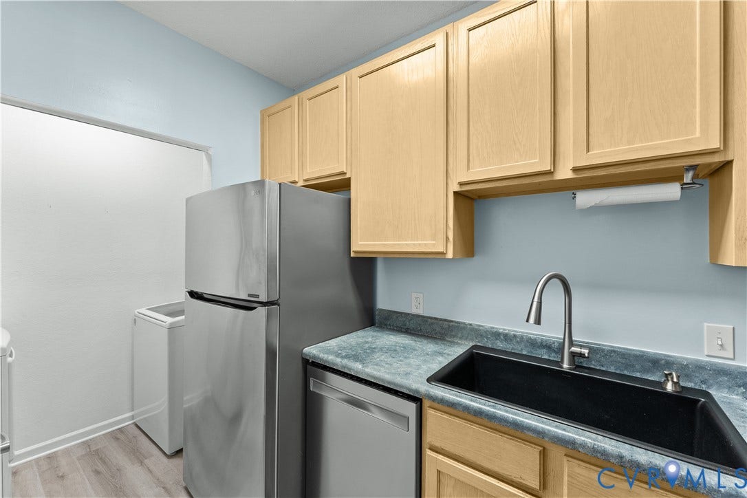 821 Brassie Lane, #E, The Crossings Golf Course Area, Glen Allen, VA 23059 Utility space featuring light wood-finish cabinetry, stainless steel refrigerator and dishwasher, laminate countertop, and deep-basin sink with arched faucet