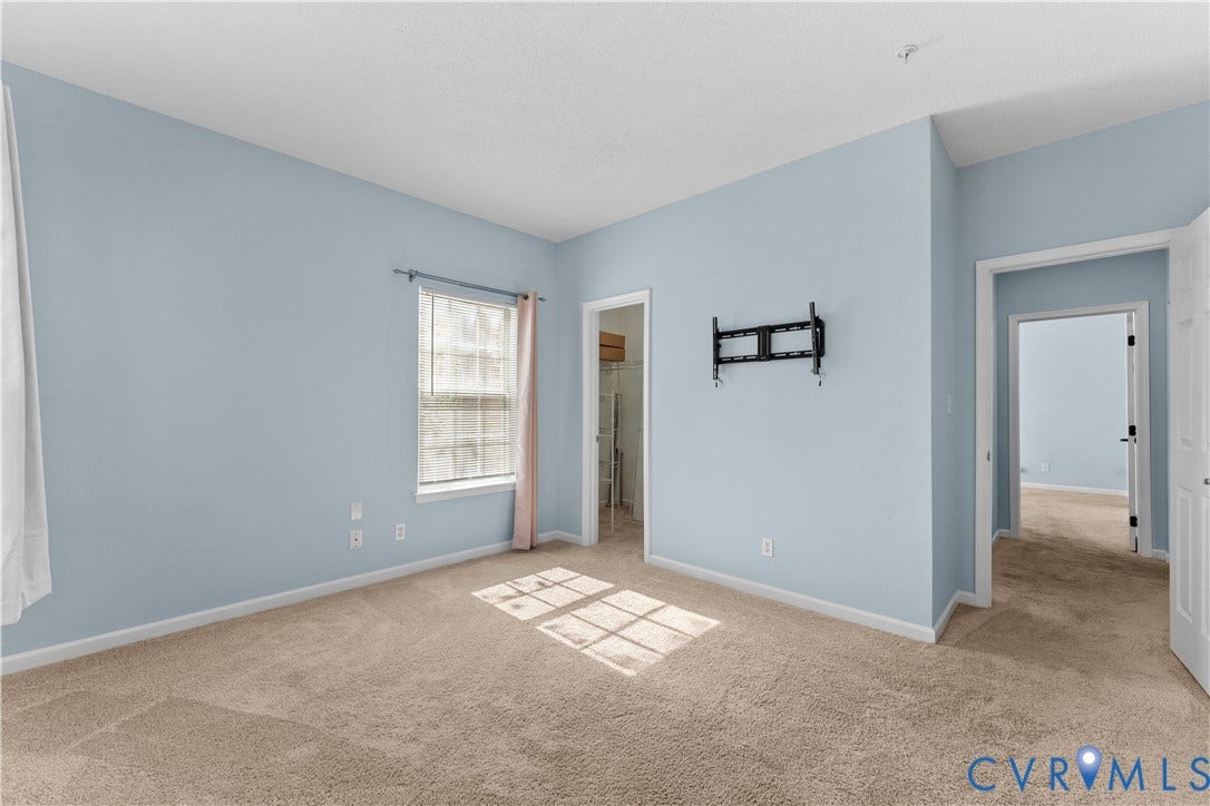 821 Brassie Lane, #E, The Crossings Golf Course Area, Glen Allen, VA 23059 Light-filled room featuring wall-to-wall carpeting, a single-hung window with a neutral finish, and an integrated walk-in closet