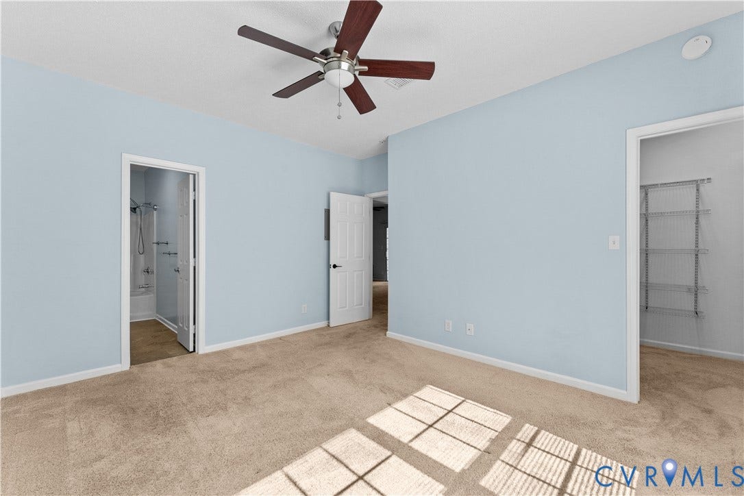 821 Brassie Lane, #E, The Crossings Golf Course Area, Glen Allen, VA 23059 Spacious room featuring neutral carpeting, a ceiling fan with dark wood-finish blades, and built-in metal shelving within the storage area
