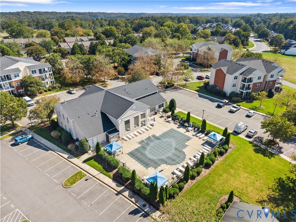 821 Brassie Lane, #E, The Crossings Golf Course Area, Glen Allen, VA 23059 Aerial perspective featuring an outdoor swimming pool, paved surface decking, designated parking area, and manicured landscaping