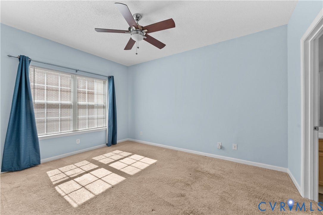 821 Brassie Lane, #E, The Crossings Golf Course Area, Glen Allen, VA 23059 Neutral-toned carpeting, five-blade ceiling fan with integrated lighting, and multi-pane window