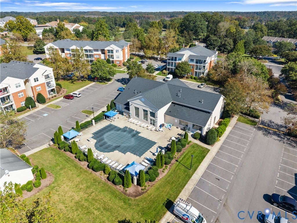 821 Brassie Lane, #E, The Crossings Golf Course Area, Glen Allen, VA 23059 Community swimming pool with a concrete deck, manicured shrubbery, and paved parking area
