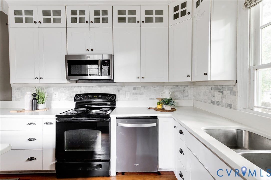 2216 E Marshall Street, Church Hill North, Richmond, VA 23223 White cabinetry with glass-front upper doors, stainless steel microwave, black electric range, stainless steel dishwasher, and a double basin stainless steel sink