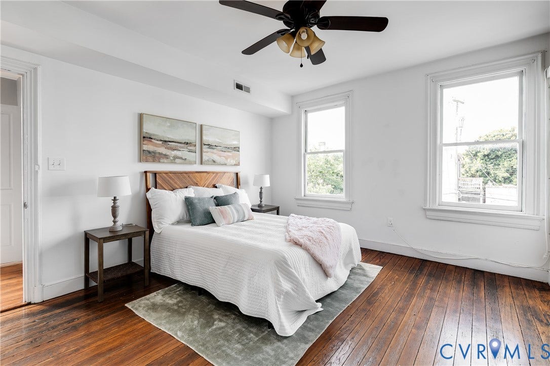 2216 E Marshall Street, Church Hill North, Richmond, VA 23223 Hardwood flooring, two large windows, a ceiling fan, and white painted walls