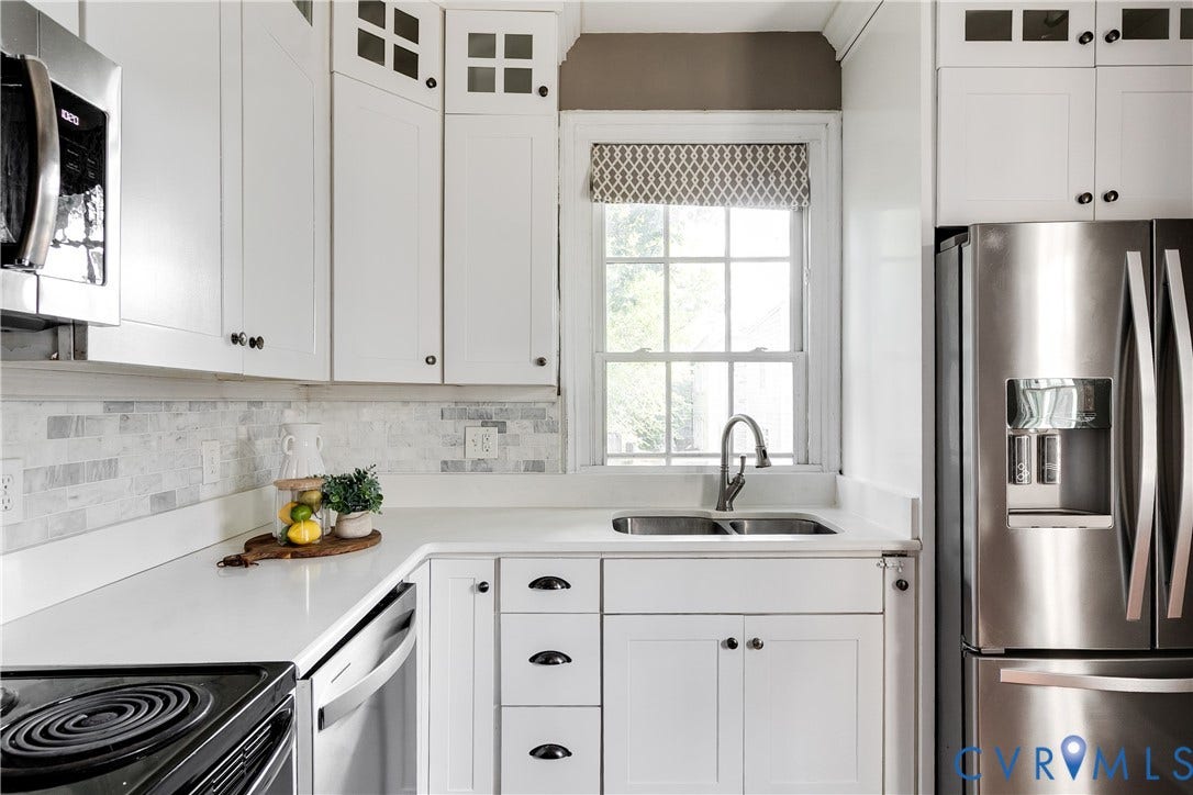 2216 E Marshall Street, Church Hill North, Richmond, VA 23223 White shaker cabinetry, stainless steel appliances, stone countertops, dual basin sink, and tile backsplash