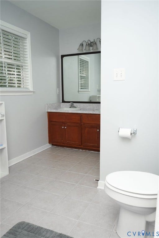 15349 Featherchase Drive, Chesterfield, VA 23832 Vanity with wood-finish cabinetry, light-toned countertop, and mirror with an overhead light fixture