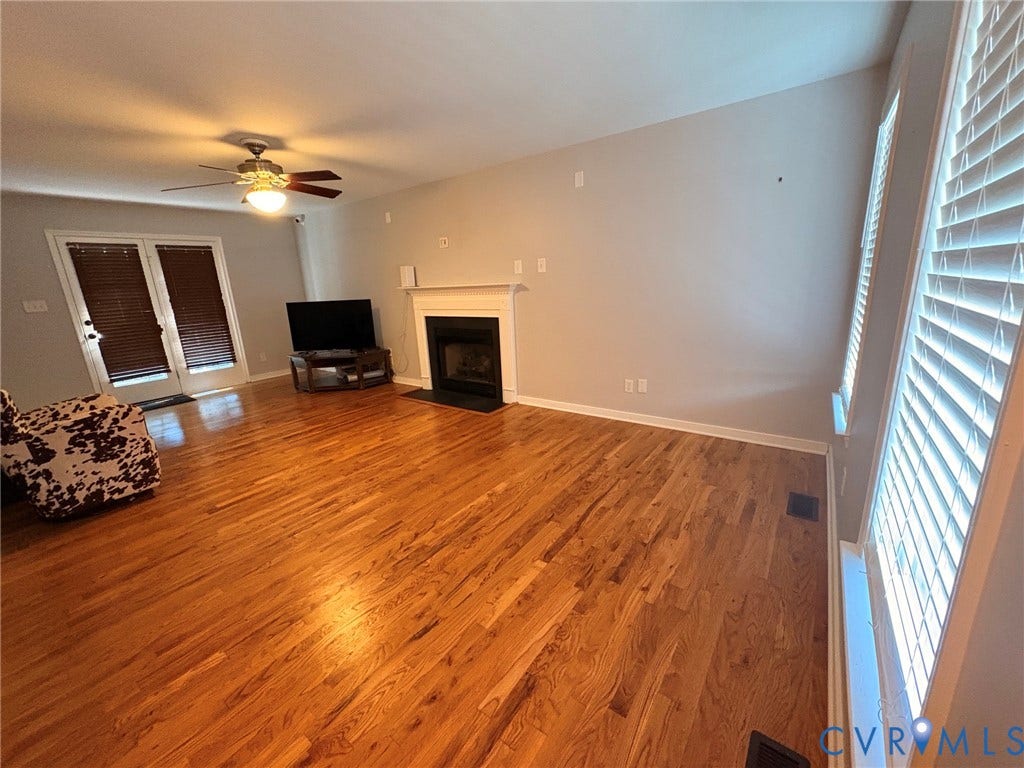 15349 Featherchase Drive, Chesterfield, VA 23832 Hardwood flooring, fireplace with mantel, ceiling fan, double French doors, and window blinds