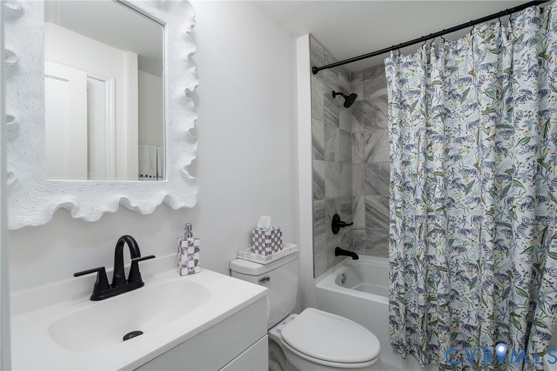 1204 Maywood Road, Beverly Hills, Henrico, VA 23229 White vanity with integrated sink, black-finish faucet, and coordinating mirror
