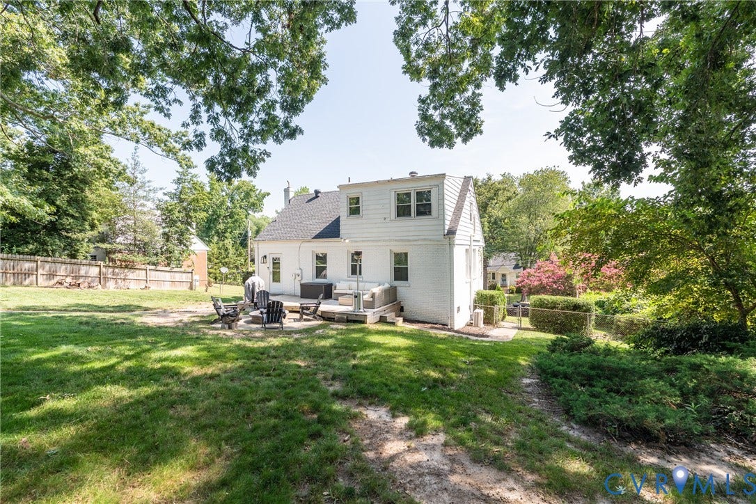 1204 Maywood Road, Beverly Hills, Henrico, VA 23229 Expansive backyard with a manicured lawn, dedicated patio space, and mature trees