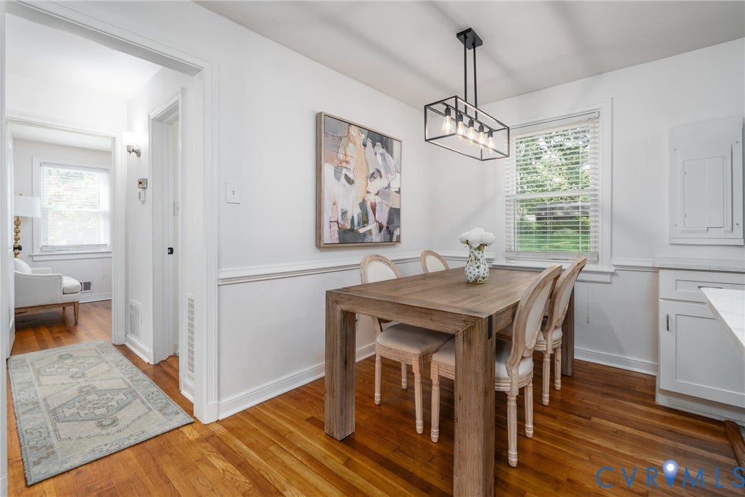 1204 Maywood Road, Beverly Hills, Henrico, VA 23229 Hardwood flooring, painted white walls, picture rail molding, and a modern rectangular chandelier