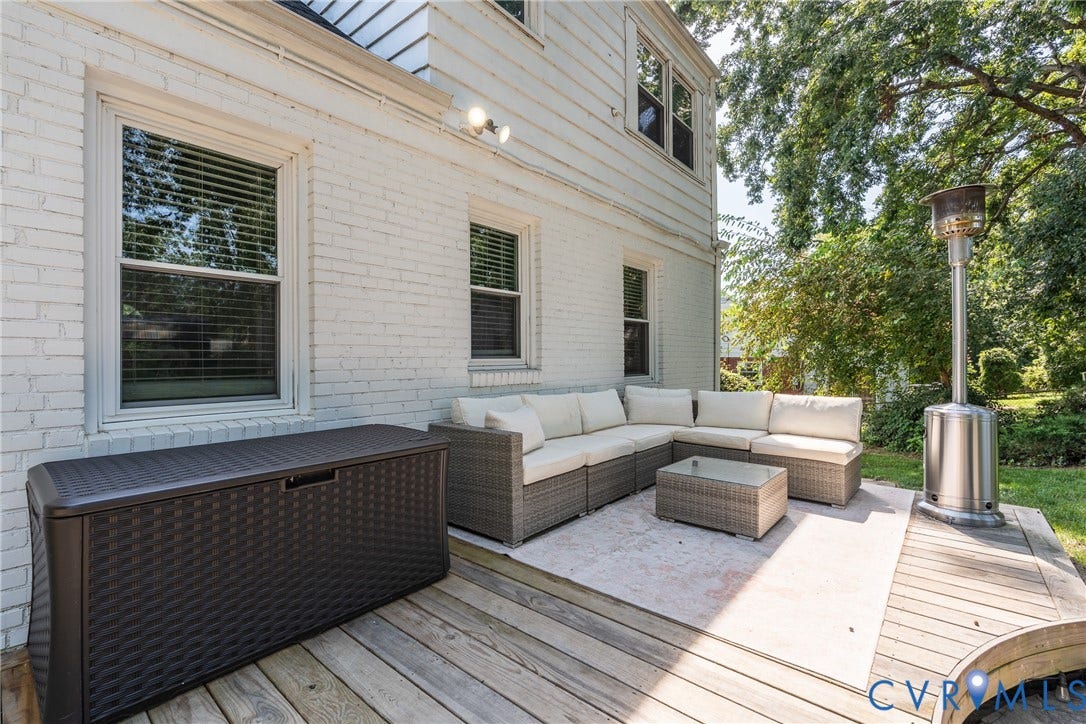 1204 Maywood Road, Beverly Hills, Henrico, VA 23229 White brick exterior with dual windows, wood deck, and concrete patio