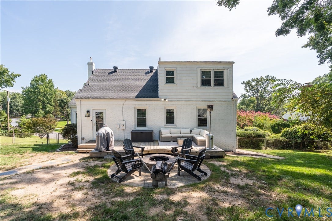 1204 Maywood Road, Beverly Hills, Henrico, VA 23229 Expansive backyard with a wooden deck, stone fire pit, and mature trees