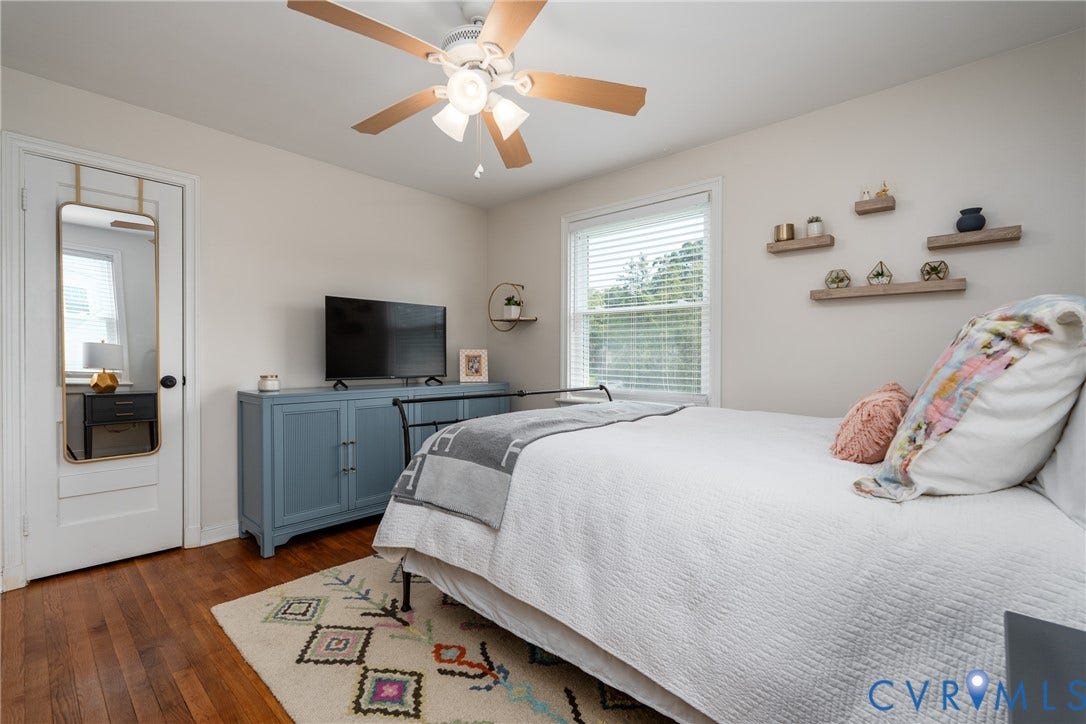 1204 Maywood Road, Beverly Hills, Henrico, VA 23229 Hardwood flooring, ceiling fan with light fixture, large window with blinds, and built-in wall shelving