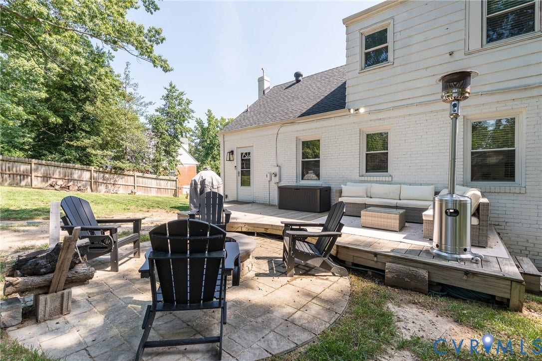 1204 Maywood Road, Beverly Hills, Henrico, VA 23229 Expansive backyard featuring a raised wooden deck, a secondary stone patio, and perimeter fencing