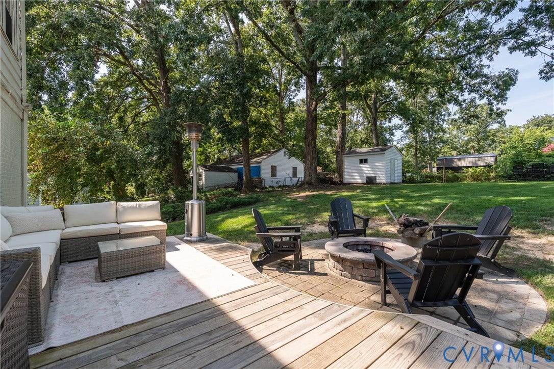 1204 Maywood Road, Beverly Hills, Henrico, VA 23229 Expansive backyard featuring a stone fire pit, wood deck, and a detached storage shed