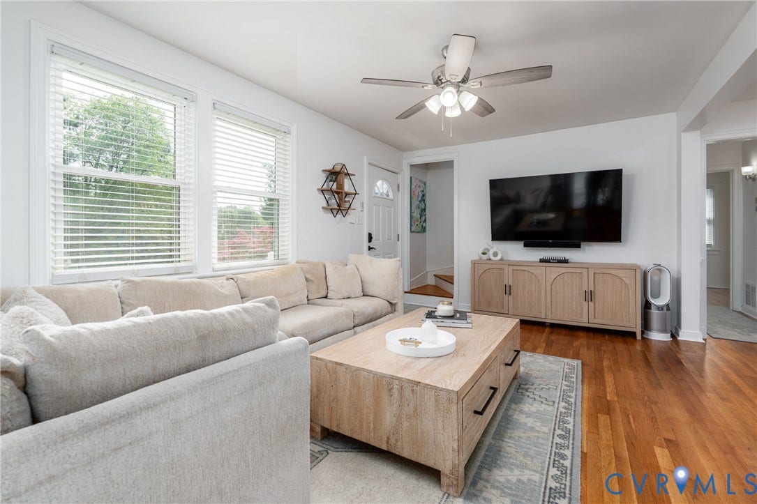1204 Maywood Road, Beverly Hills, Henrico, VA 23229 Hardwood flooring, white walls, multiple windows, ceiling fan, and a built-in media console