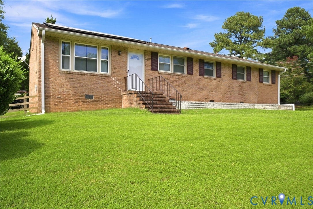 1721 S Halcun Drive, Petersburg, VA 23803 Brick exterior with white trim, dark shutters, and a front entry staircase with metal railing
