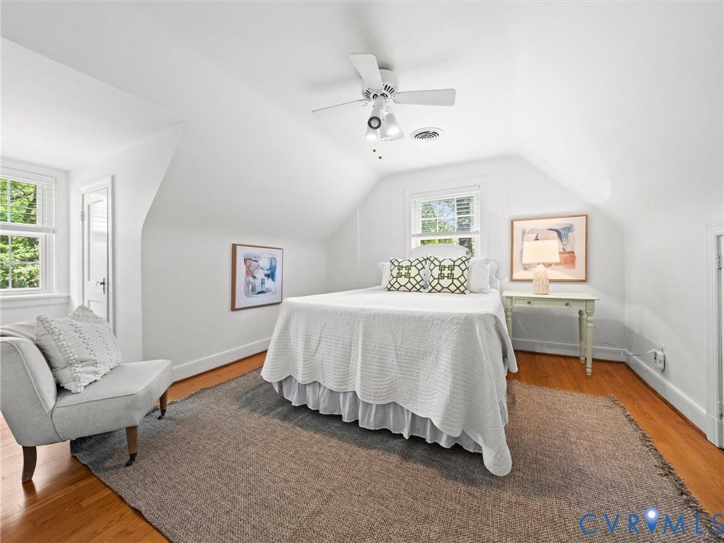 Hardwood flooring, painted white walls, recessed window, ceiling fan, and sloped ceiling