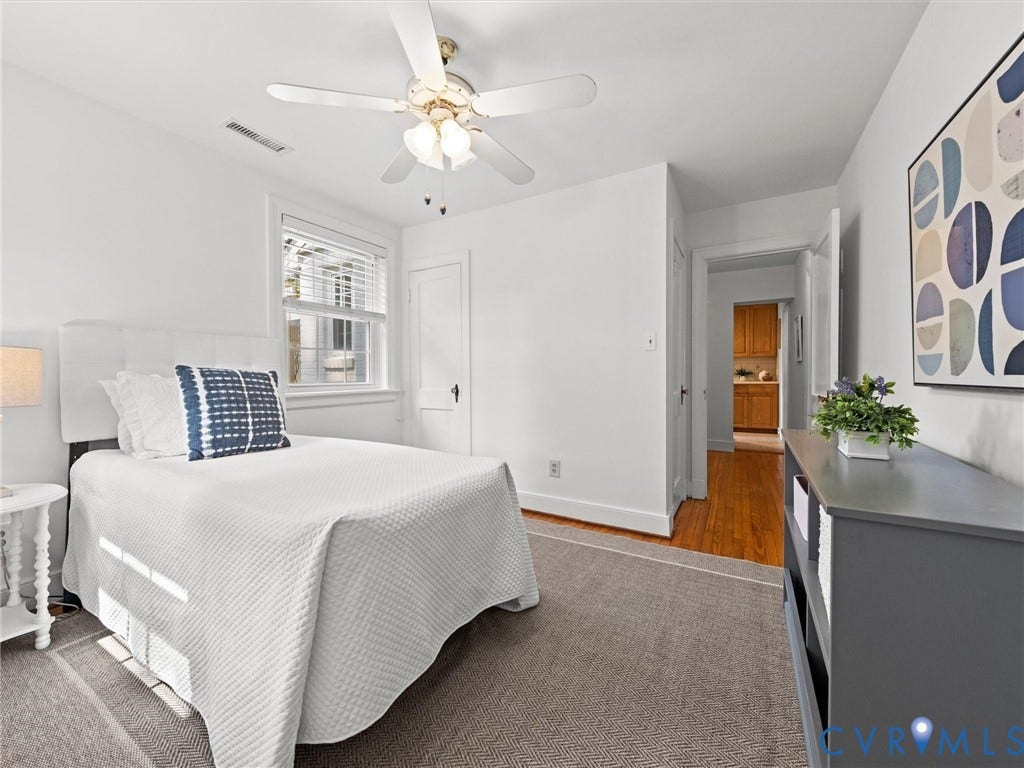 White painted walls, a window with horizontal blinds, and a ceiling fan with integrated lighting