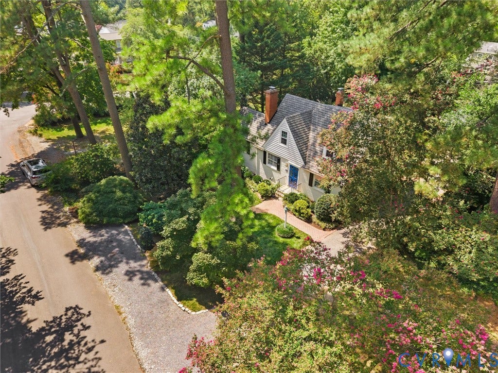 Charming Colonial-style residence nestled among mature trees and lush landscaping