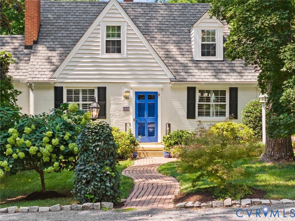 White brick exterior with black window shutters