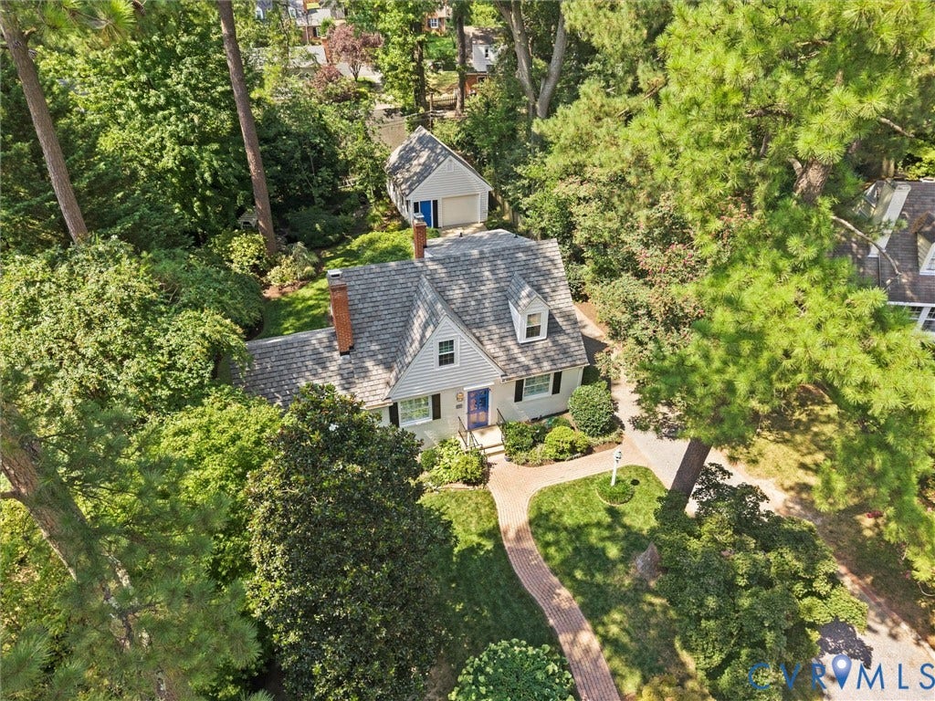 Gable roofline, red brick chimney, dormer window, detached accessory structure, paver walkway