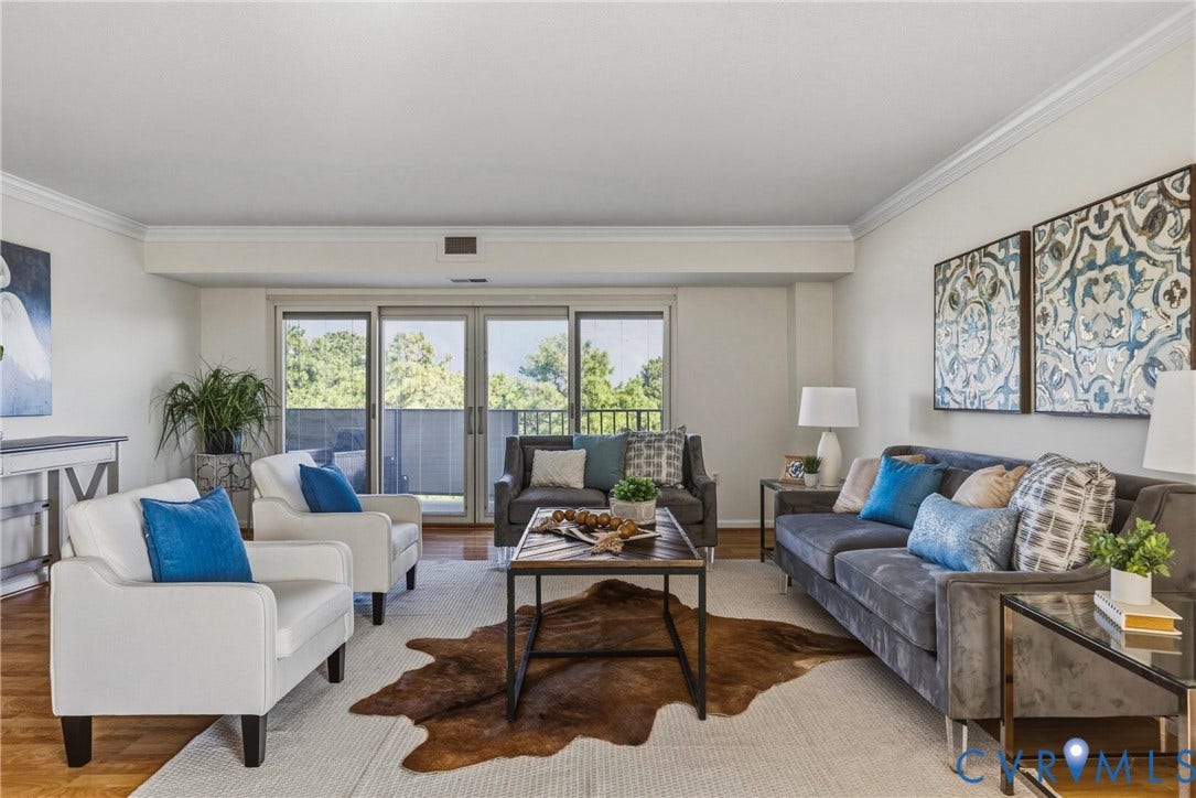 Lots of natural light, LVP flooring throughout the living spaces and sliding glass Pella doors to access large balcony
