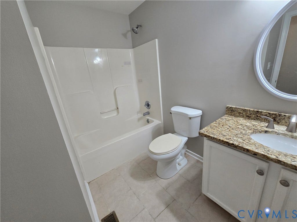 1019 Arizona Drive, Woodhaven, Richmond, VA 23224 White acrylic shower and tub combination, light-toned tile flooring, and a vanity with a granular countertop