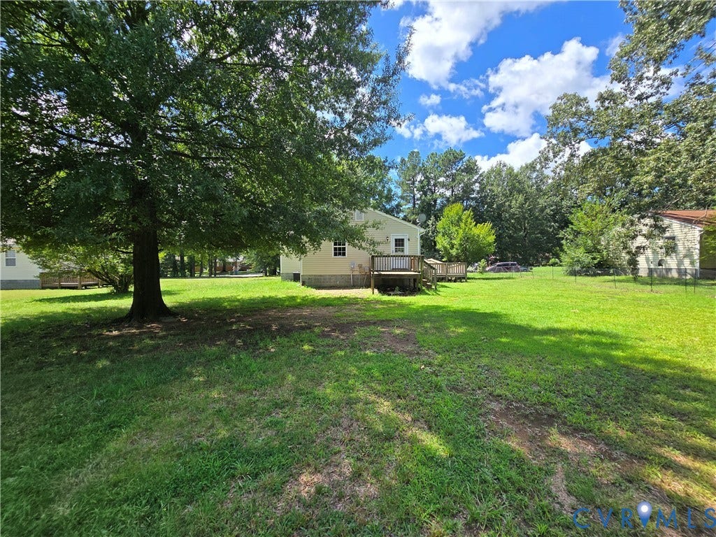 1019 Arizona Drive, Woodhaven, Richmond, VA 23224 Expansive grassy yard with mature trees and a rear deck