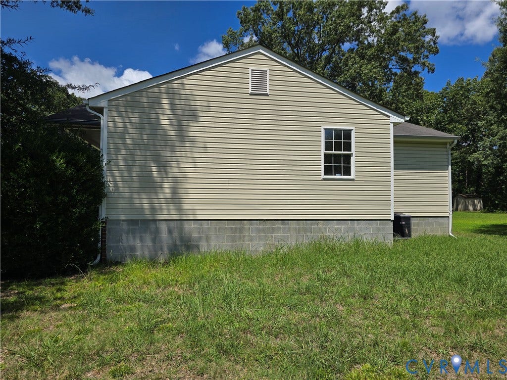 1019 Arizona Drive, Woodhaven, Richmond, VA 23224 Beige vinyl siding with white trim, a double-hung window, and a foundation of concrete blocks