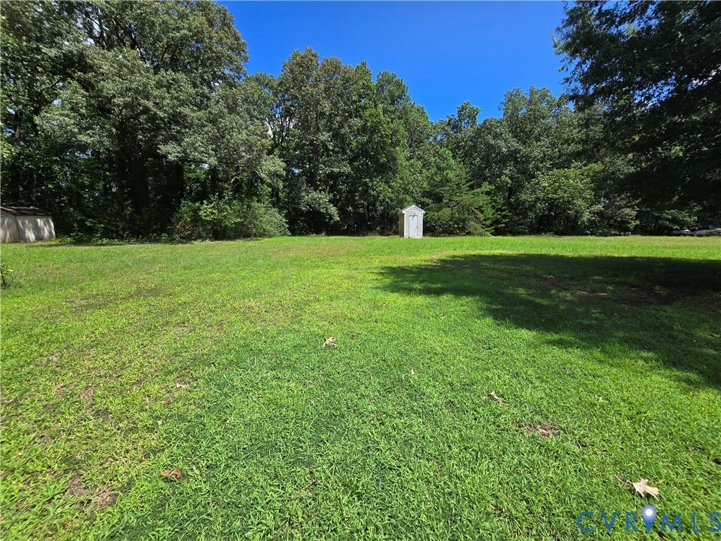 1019 Arizona Drive, Woodhaven, Richmond, VA 23224 Expansive green lawn with mature trees and a detached storage shed