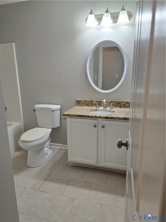 1019 Arizona Drive, Woodhaven, Richmond, VA 23224 White vanity with cabinet storage, granite-style countertop, oval mirror, modern light fixture, and tile flooring