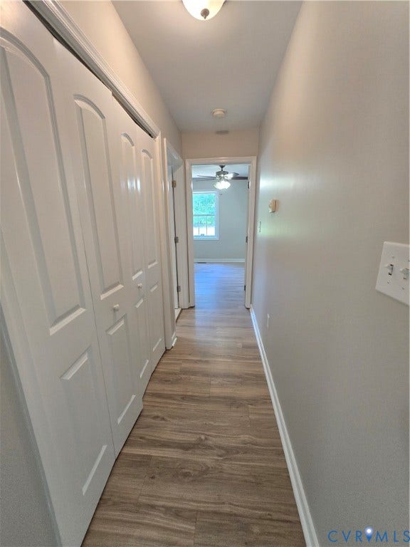 1019 Arizona Drive, Woodhaven, Richmond, VA 23224 Hallway featuring wood-finish flooring, white paneled doors, and flush-mount lighting