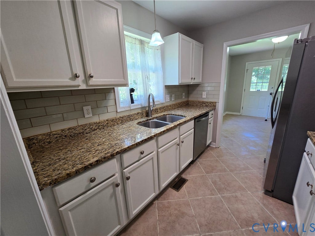 1019 Arizona Drive, Woodhaven, Richmond, VA 23224 Kitchen featuring white cabinetry, granite countertops, a subway tile backsplash, and a double basin stainless steel sink