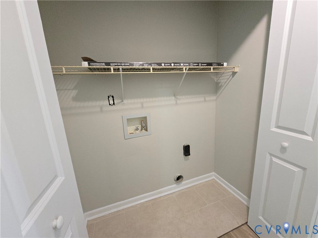1019 Arizona Drive, Woodhaven, Richmond, VA 23224 Laundry closet with wire shelving, tile flooring, and bi-fold doors